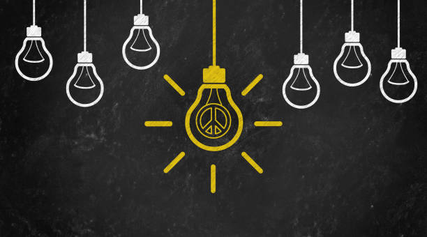 istock peace Symbol with Bulb Concept Chalk Drawing on Blackboard 1144645863