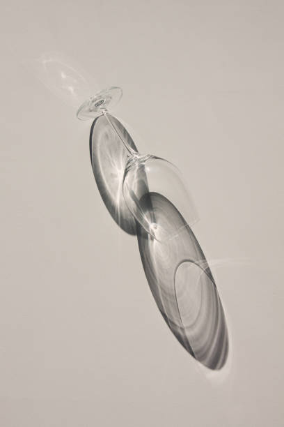istock Wine glass lying on the table. Abstract shadows, sunlight, top view. 1144645938