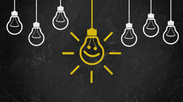 istock smile Symbol with Bulb Concept Chalk Drawing on Blackboard 1144646038