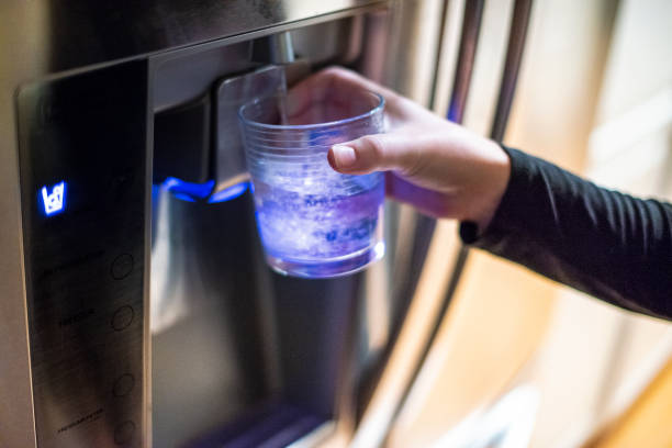 Dispensing Water from Refrigerator stock photo