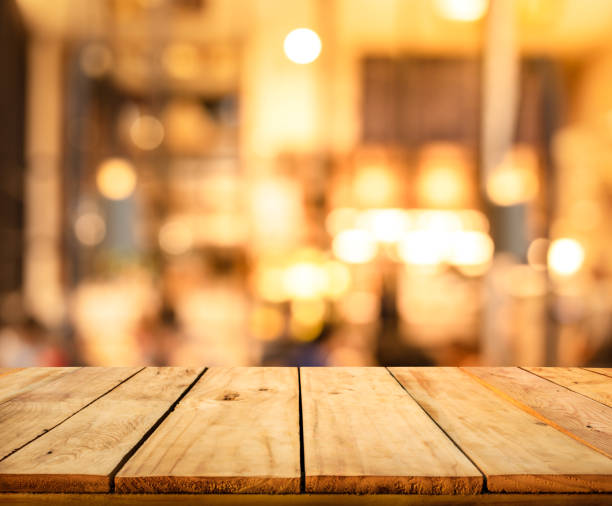 istock Wood texture table top (counter bar) with blur light gold bokeh in cafe,restaurant background 1144649699
