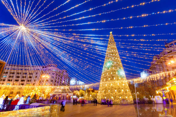 Beautiful Christmas scene in Bucharest capital Beautiful Christmas scene with tree decorations outdoor, in Revolutiei square of Bucharest in Romania bucharest stock pictures, royalty-free photos & images