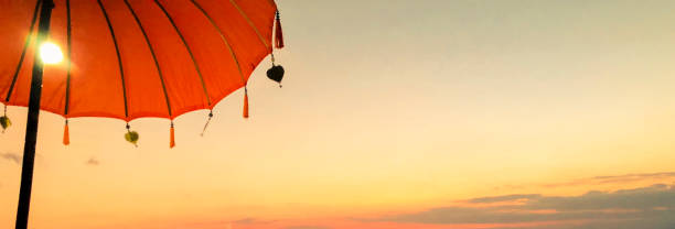 istock Travel ideas, tropical paradise, umbrella and sunset 1144652375