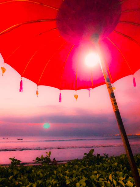 istock Tropical sunset in Bali with quaint colorful umbrellas 1144652408