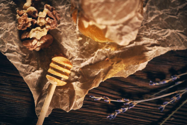 Jar of honey with walnut on wooden table
