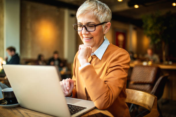 istock Smiling senior business woman using laptop. 1144654150
