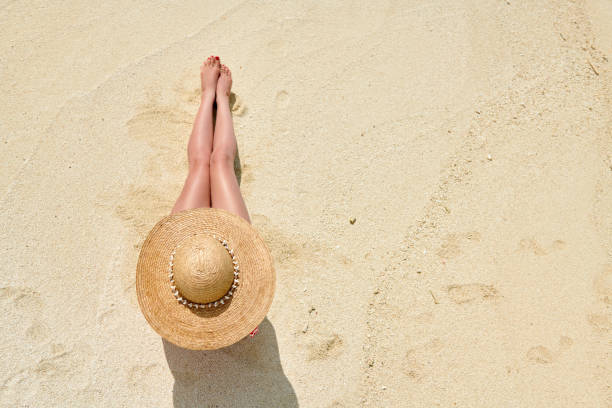 istock Woman sitting on beach view from above 1144656825