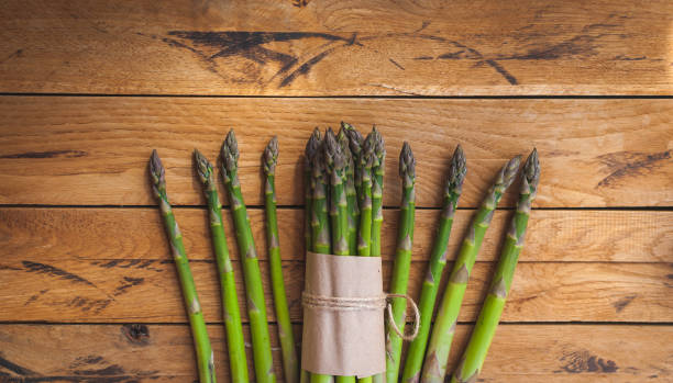 istock Fresh green asparagus on wooden background, top view, text space, copy space 1144658813