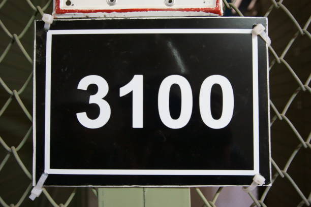 istock A black table attached to a fence with number three thousands one hundered (3100) 1144661154