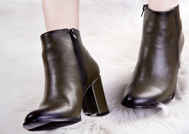 istock Beautiful female legs in spring boots. 1144663637
