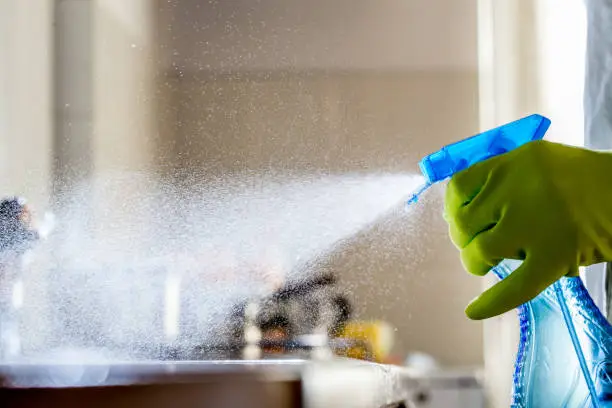 Spraying Cleaning Product on the Kitchen Counter.