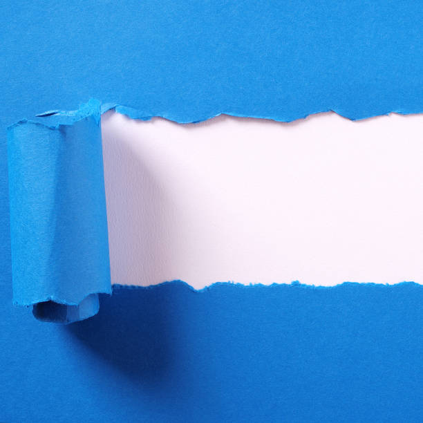 istock Torn blue paper strip curled edge border white background 1144664780