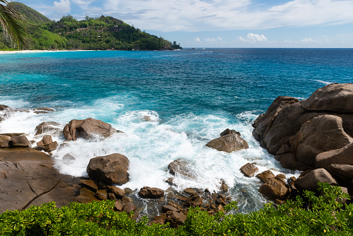 Wild Seychelles lagoon with rocks and greens. Indian ocean view with turquoise water.
