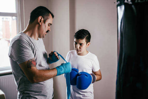 istock Young boy boxer preparing for boxing with coach 1144670006
