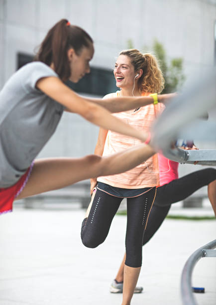 istock Girls doing streching exercises outdoors 1144670152