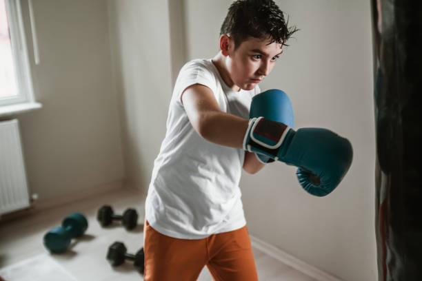 istock Child training boxing with punching bag 1144670315