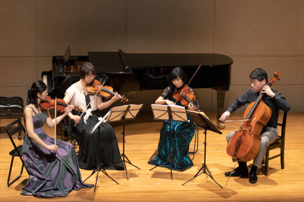 istock Violinists and cellist playing at classical music concert 1144671118