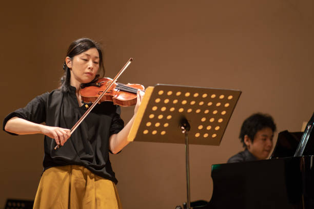 istock Violinist and pianist playing at classical concert 1144671133