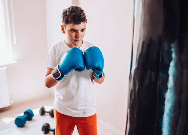istock Child training boxing with punching bag 1144672259