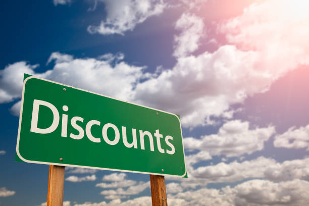 istock Discounts Green Road Sign Against Sky 1144672636