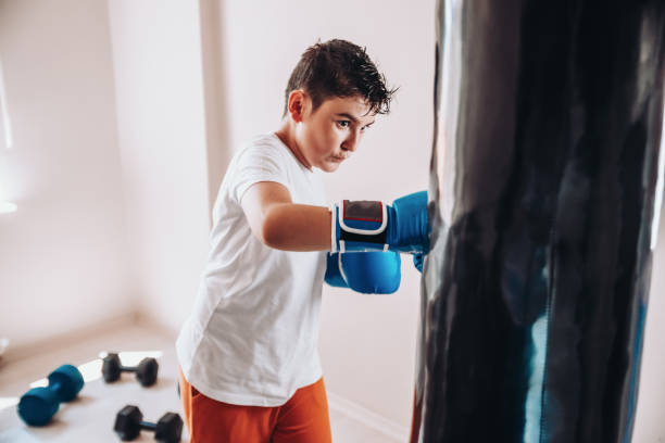 istock Child training boxing with punching bag 1144672658