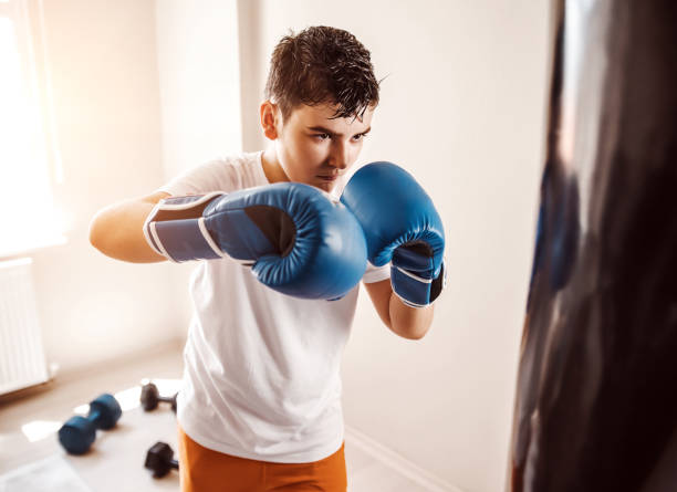 istock Child training boxing with punching bag 1144673382