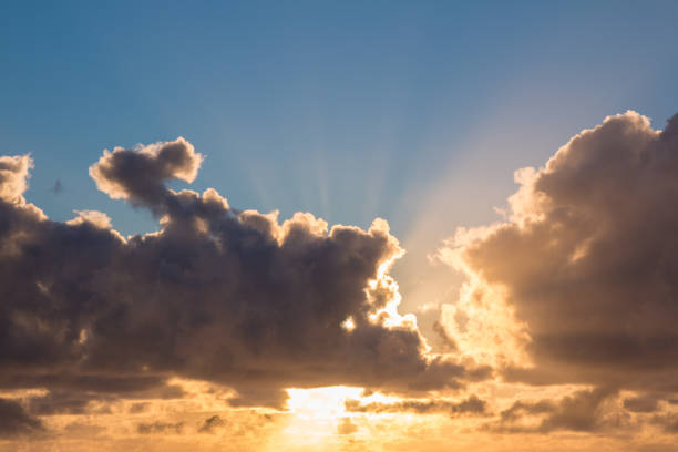 istock Sunrise with blue sky and sun behind the clouds 1144673514