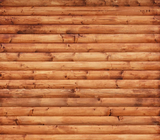 Wooden wall assembled of beams or logs This is an old wooden wall assembled of beams or logs. gnarly wood texture stock pictures, royalty-free photos & images