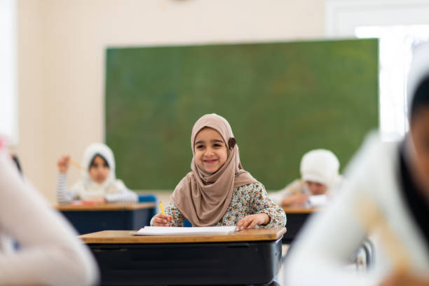 istock Smiling muslim girl writing 1144680043