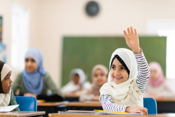 istock Muslim girl raising her hand 1144680071
