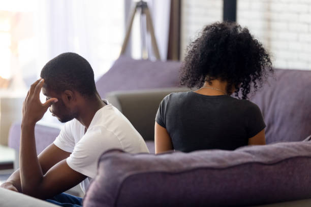 istock Rear view black couple sitting separately on couch not talking 1144680214