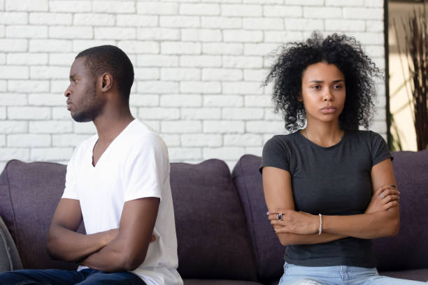 istock Unsatisfied married couple sitting separately on couch and not talking 1144680224