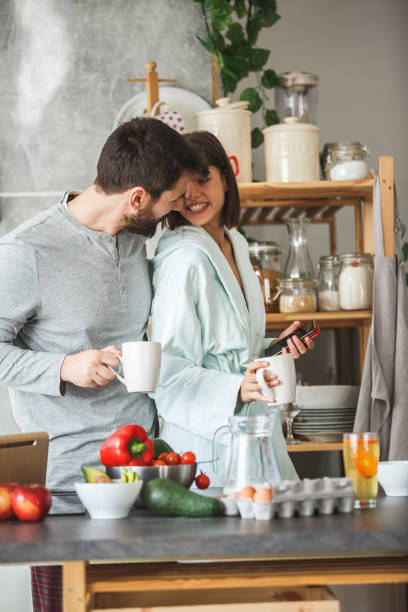 istock Affectionate couple having morning coffee in the kitchen 1144680251