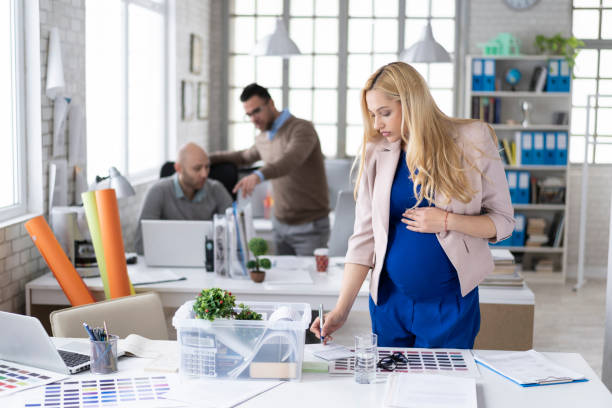 istock Pregnant woman preparing for leaving workplace 1144682975