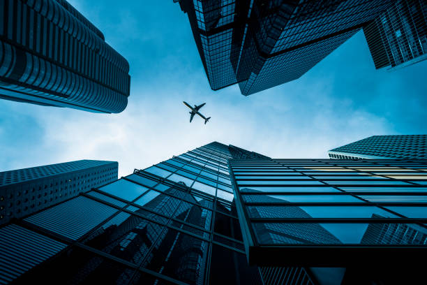 istock Skyscrapers with a airplane silhouette 1144689578