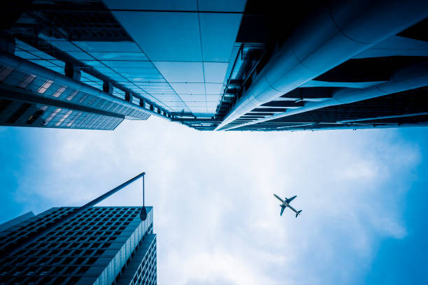 istock Skyscrapers with a airplane silhouette 1144689591