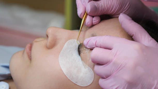 istock Eyelash Extension Procedure. Woman Eye with Long Eyelashes 1144699172