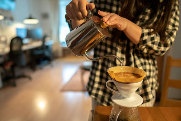istock girl making coffee with coffee filter 1144701133