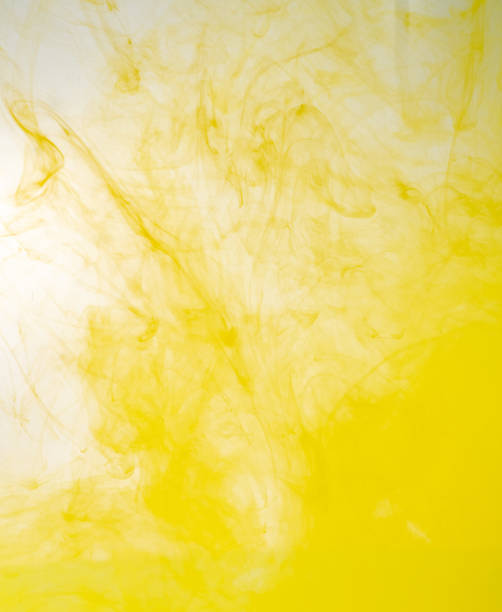 istock Yellow acrylic paint dissolving into water, close up view. Blurred background. Yellow abstract pattern of ink in liquid. Acrylic clouds mixing with water, abstract background. 1144706685