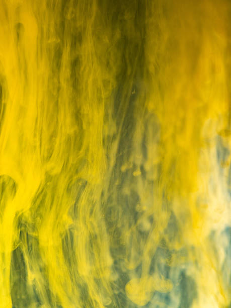 istock Yellow paint dissolving into water, close up view. Blurred background. Acrylic ink flows mixing with liquid, abstract pattern. Droplet of ink transformation in water, abstract background. 1144706693