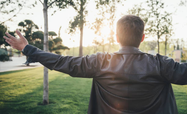 istock pjot from man`s back / man watching sunrise 1144709874