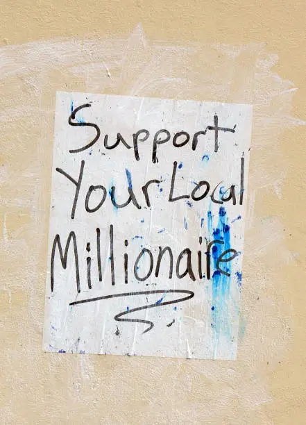 Improvised handwritten poster message glued on a building wall