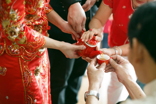 Newlywed serving tea to elder on Chinese traditional tea ceremony