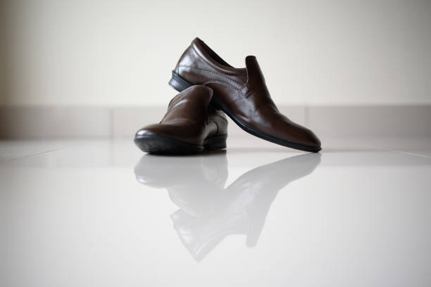 istock A pair of black leather shoe on floor with reflection 1144716457