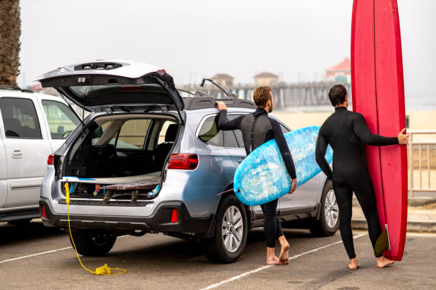 istock Surfers Stand Next to Their Car and Check Out the Waves 1144717816