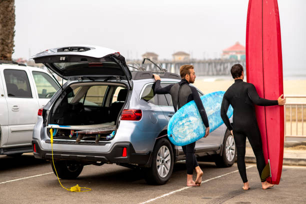 istock Surfers Stand Next to Their Car and Check out the Waves 1144719089
