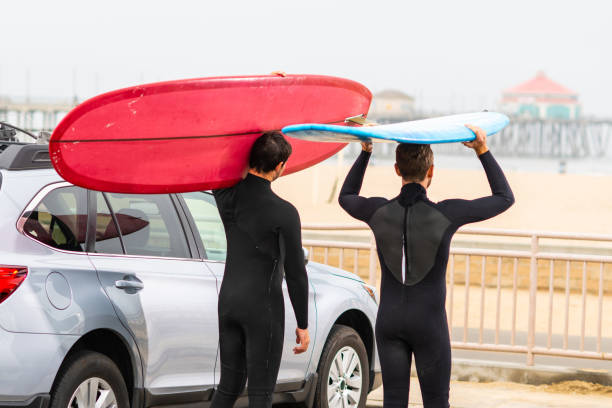 istock Surfers Stand Next to Their Car and check Out the Waves 1144719172
