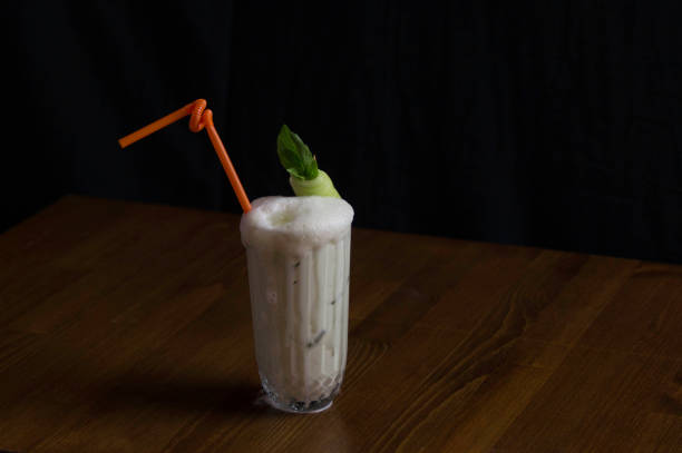 istock under artificial light a glass of buttermilk and pipette 1144721346
