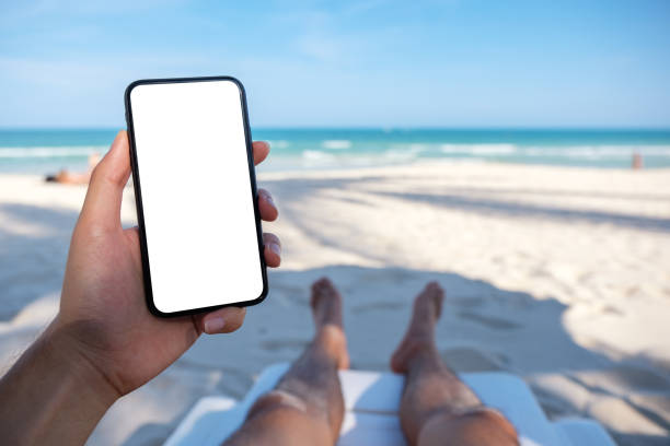 istock a man's hand holding white mobile phone with blank desktop screen 1144727527