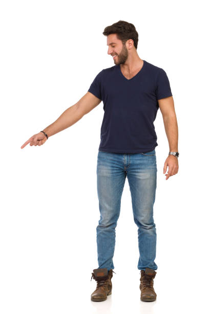 istock Smiling Handsome Man In Jeans T-Shirt And Boots Is Pointing Down And Looking 1144727676